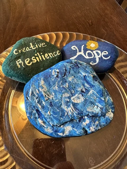 Hand-painted rocks reading Hope and Creative Resilience